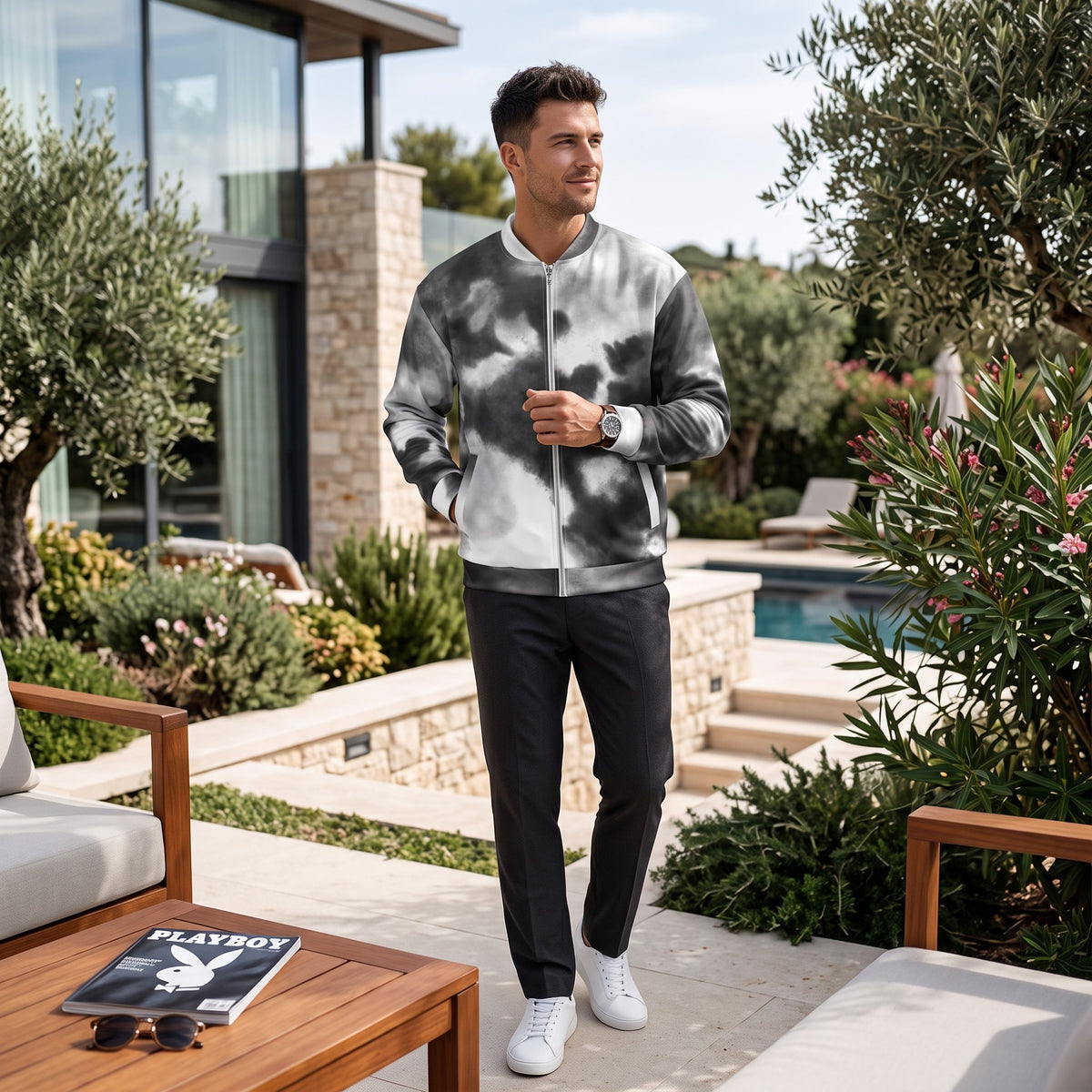 Good Wishes 365 unisex black and white watercolor print bomber jacket with silver zipper worn by a man outdoors.
