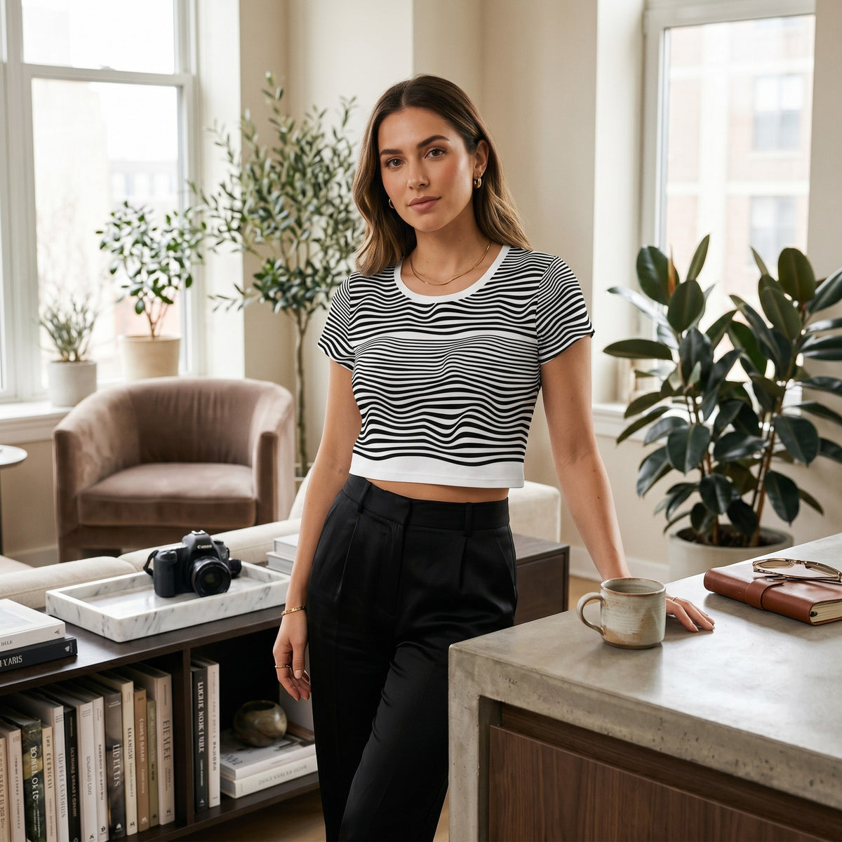 Good Wishes 365 crop tee with black and white wavy line print, worn by a woman in a modern living room.
