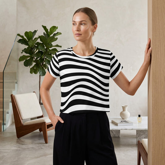 Good Wishes 365 crop tee with black and white wavy groovy lines, worn by a woman in a modern minimalist living room.