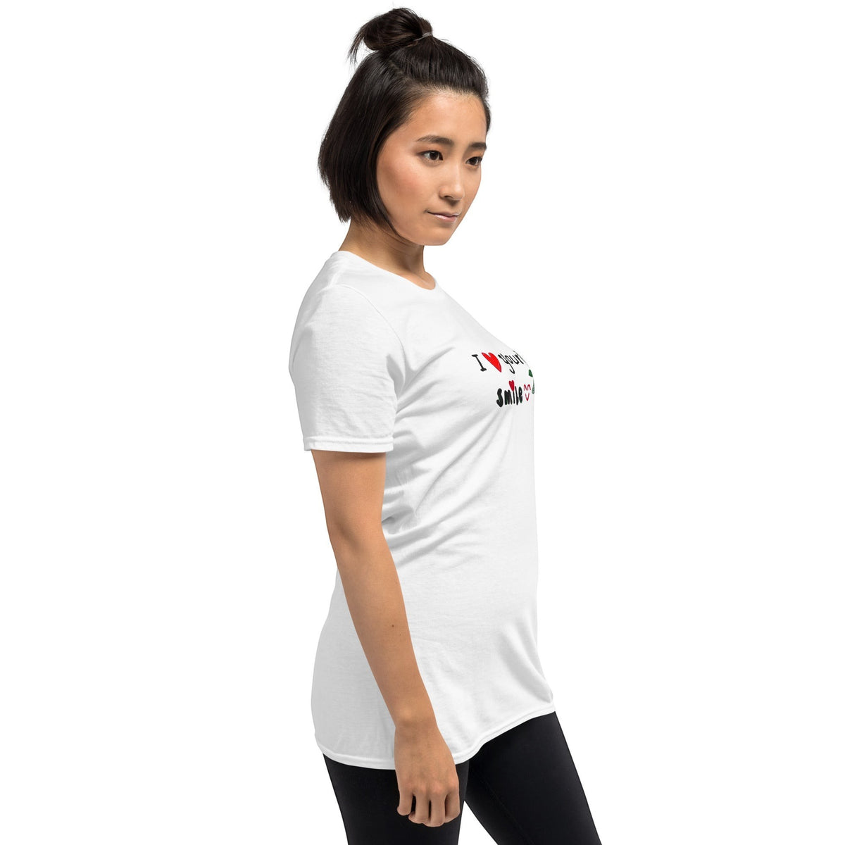 A woman wearing a Good Wishes 365 white crewneck t-shirt with I Love Your Smile graphic text and heart accents.