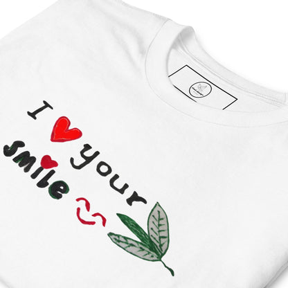 Good Wishes 365 white crewneck t-shirt featuring I Love Your Smile graphic with red heart and green leaf accents