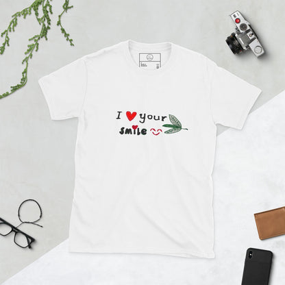 Good Wishes 365 white unisex crewneck t-shirt featuring an I Love Your Smile graphic with red hearts and a green leaf.