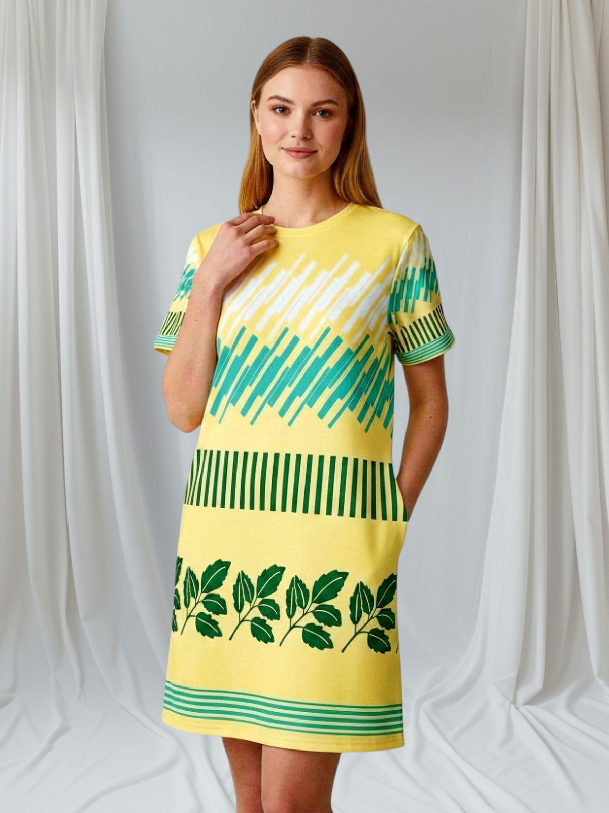 Good Wishes 365 yellow t-shirt dress with green leaf print and geometric pattern. Comfortable oversize fit, drop shoulders, mid-weight jersey.