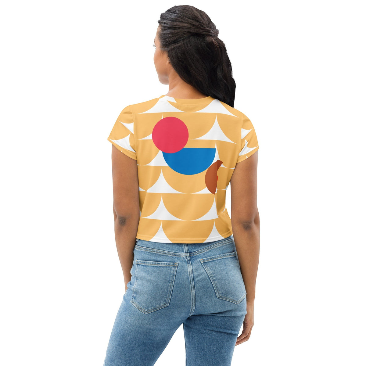 Good Wishes 365 yellow crop tee with geometric mushroom pattern worn by a woman, back view with blue jeans