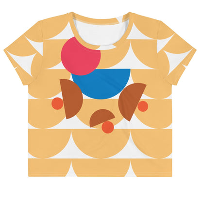Good Wishes 365 yellow crop tee featuring a geometric mushroom-inspired abstract pattern in blue, red, and terracotta.