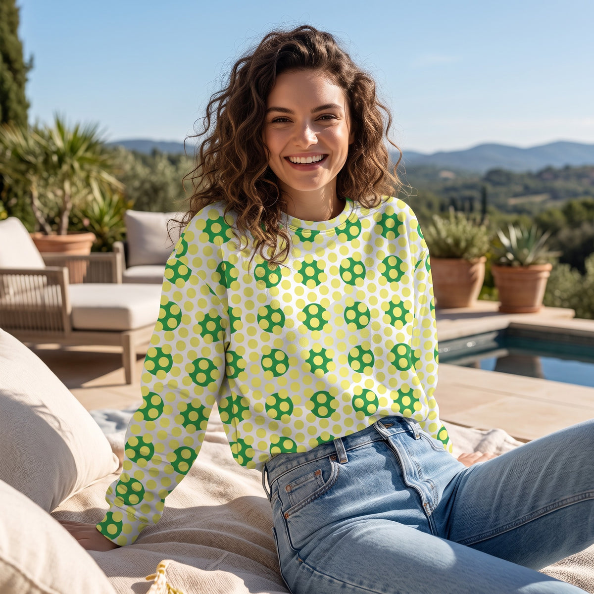 Good Wishes 365 recycled sweatshirt with 70s pop art yellow and green geometric pattern worn by a smiling woman