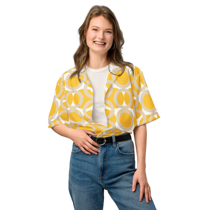 Good Wishes 365 yellow retro geometric print button-up shirt with camp collar worn by a smiling woman in blue jeans.