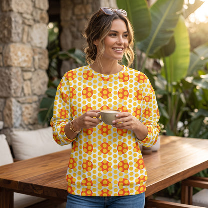 Good Wishes 365 yellow and orange geometric pop art sweatshirt with a crew neck, worn by a woman holding a coffee cup.