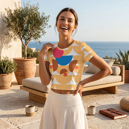 Good Wishes 365 yellow crop tee featuring a geometric mushroom graphic, worn by a smiling woman on a sunny patio.