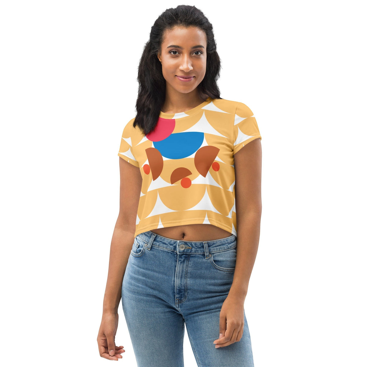 Good Wishes 365 yellow crop tee with geometric mushroom graphic in blue, red, and terracotta worn by a woman.
