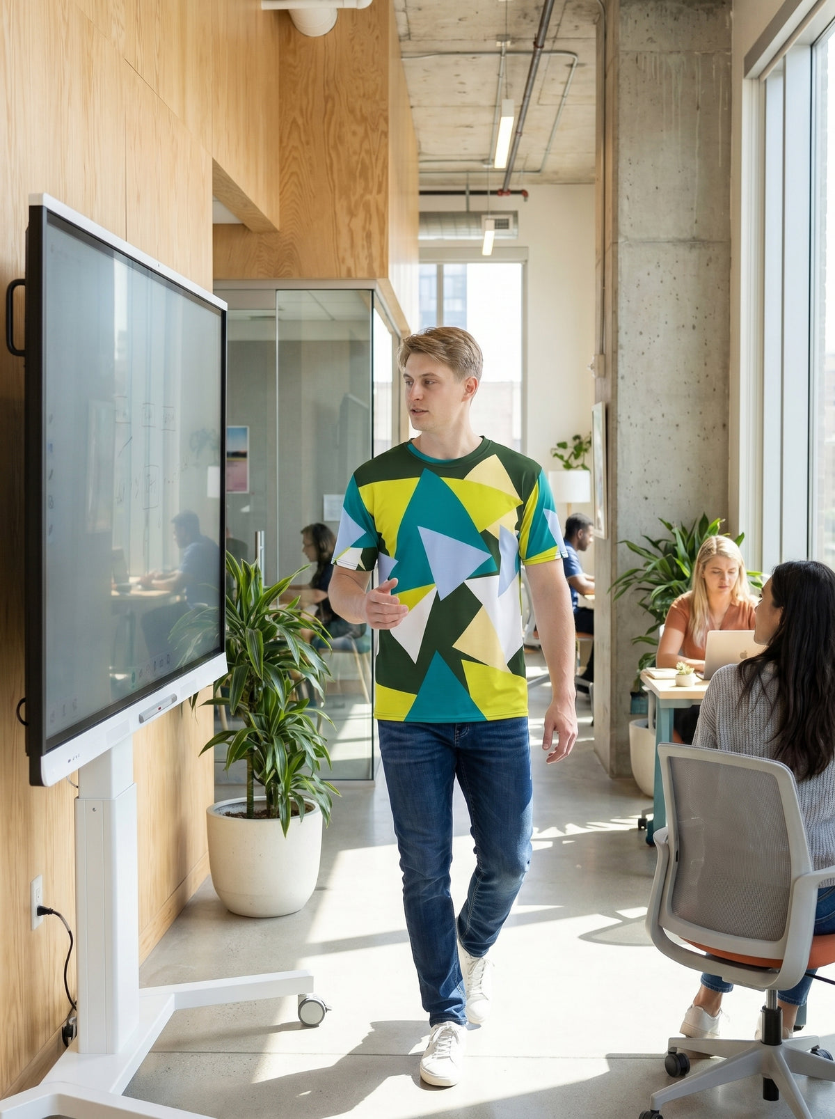 AI-generated mockup: A man in the 'Myrtle Green Abstract Triangles Crew Neck T-Shirt' is deeply focused, collaborating on