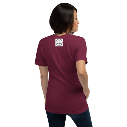 a woman in a pink shirt is standing on a bench 